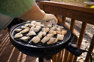 Grilling fish on the porch on an indoor-outdoor electric grill