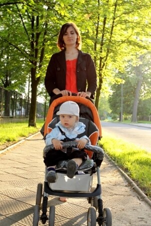Mother pushing her baby in a travel system stroller