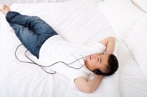 Man reclining and listening to his iPod