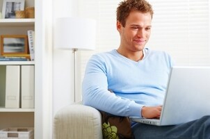Man looking at a laptop at home