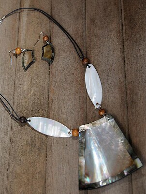 A large shell pendant and shell earrings