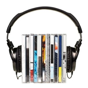Headphones resting on a stack of CD jewel cases