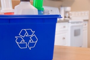 Recycling bin in the kitchen full of plastic bottles