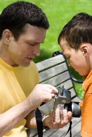 Man inserting a memory card into his camera
