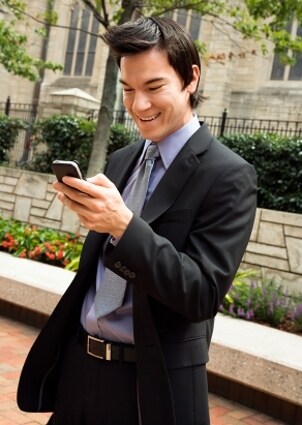 Young business man viewing his PDA screen