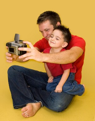 Family using camera batteries in a digital camera