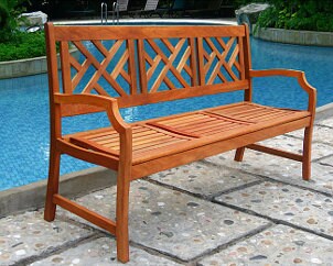 Wooden bench by an outdoor pool