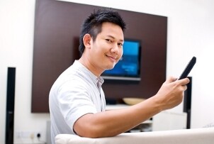 Man setting up his media center with speakers