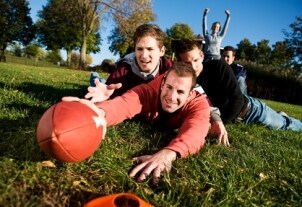Group of friends playing football in a park