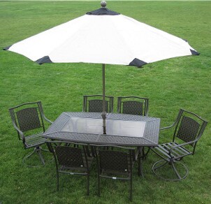 White 9-foot patio umbrella with black accents shades a patio table and chairs