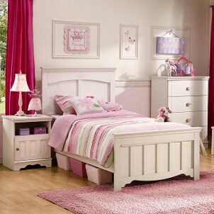 Nightstand and other bedroom furniture in a girl's bedroom