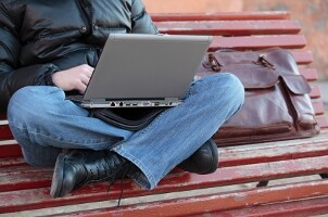Leather laptop travel bag on a bench