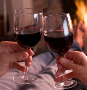 A couple toasts with red wine