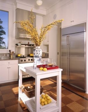 White kitchen cart holds fruit and decorative accents