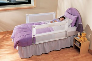 Toddler bed with safety rails and colorful bedding