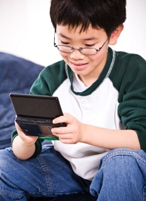 Young player with a black Nintendo DS system