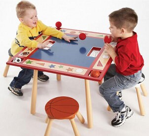Two little boys sitting at a sports themed table
