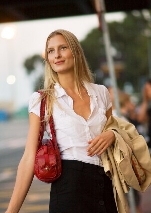 Woman carrying a red leather handbag