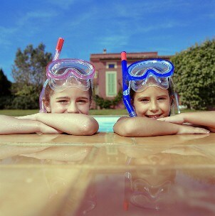 Kids swimming in a pool on vacation
