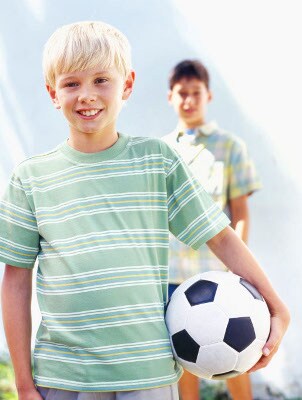 Two boys wearing summer clothes, ready to play soccer