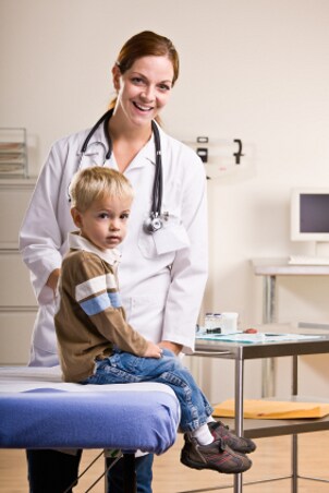 Child sitting on an exam table at the doctor's office
