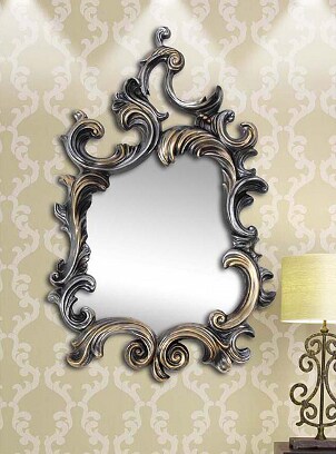 A decorative mirror hangs near a lamp
